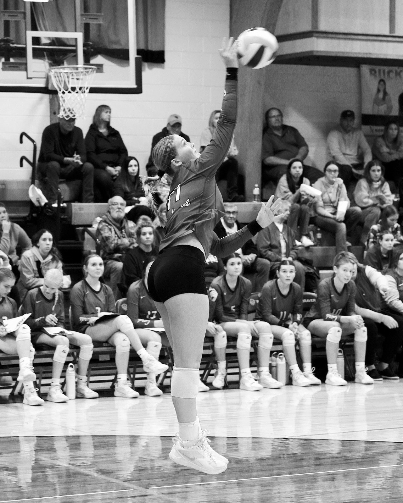 Emma Hall serves up an ace in the Cards three-set win over the Bearcats. Photo by Larry Stokke.