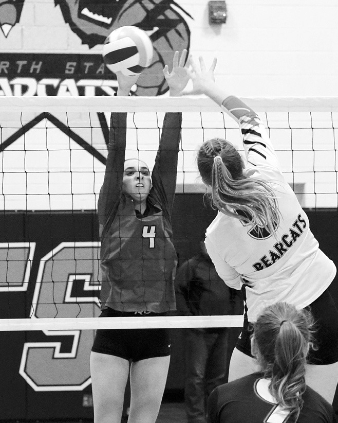 Avery Lorenz stuff blocks Bearcat Mattea Wanzek in Cando on Nov. 4. Photo by Larry Stokke.
