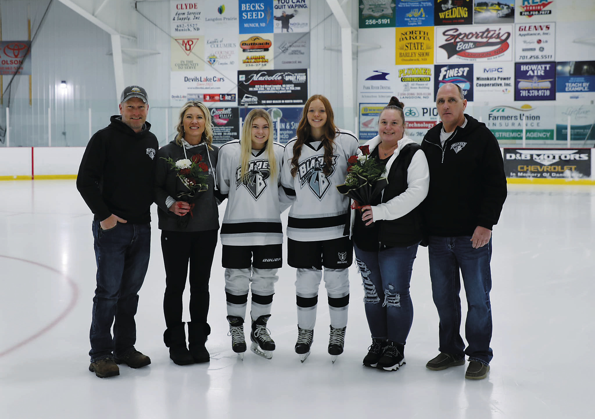 Athletes stand with their parents for Senior Night (R-L) Greg Goodman, Sara Goodman, Catelyn Goodman, Alora Berke, Jessica Berke, and Brian Hermanson. Photo by Courtney Krom.