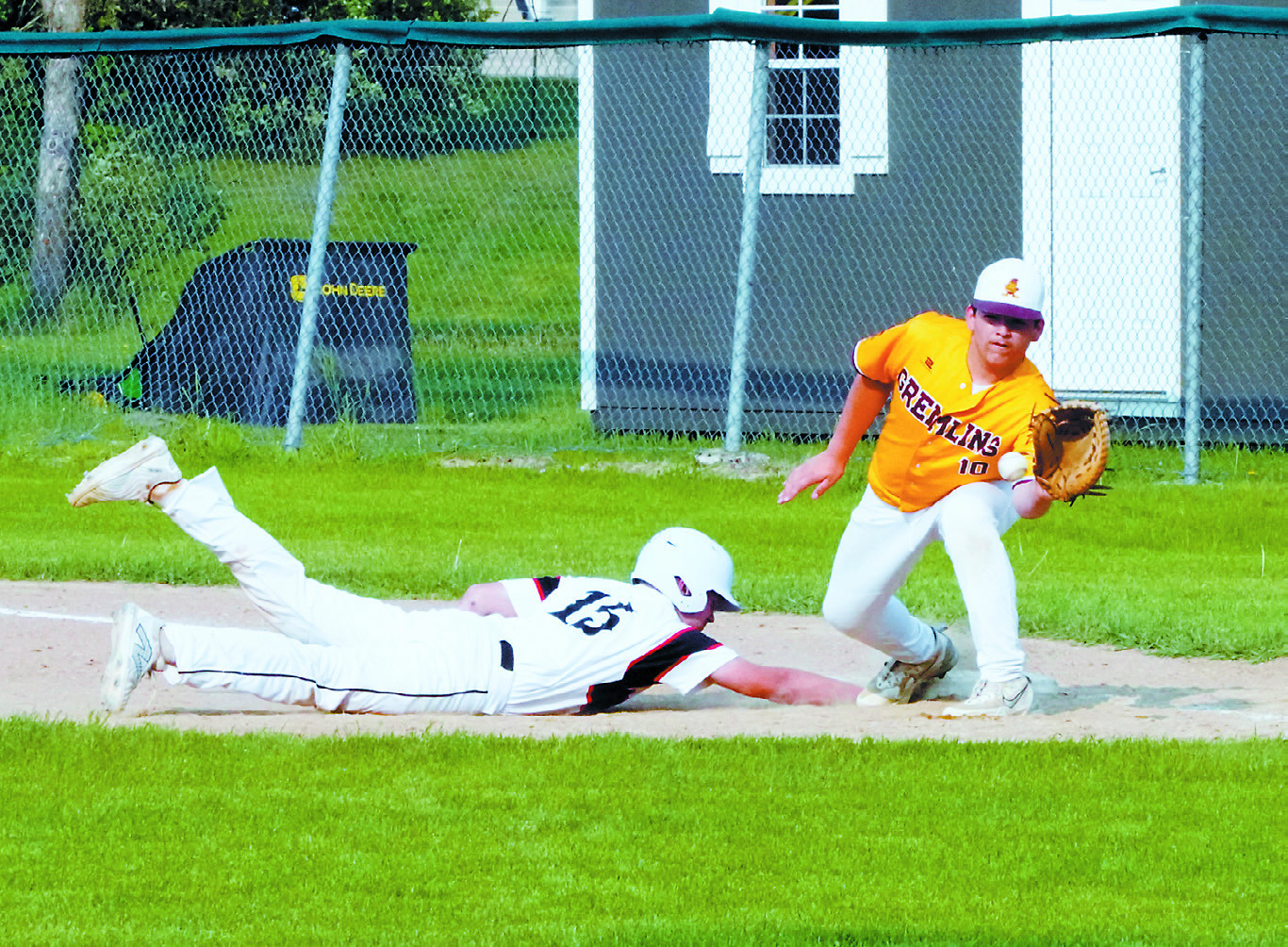 Luke Gilseth gets back to first base quickly beating the tag-out in the win over Grafton June 3 in Langdon. Photo by Larry Stokke