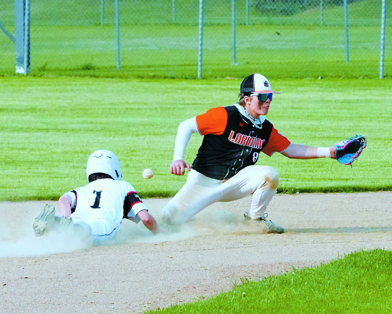 Connor Mitchell slides onto second base and gets a closeup look at a missed catch. Photo by Larry Stokke.