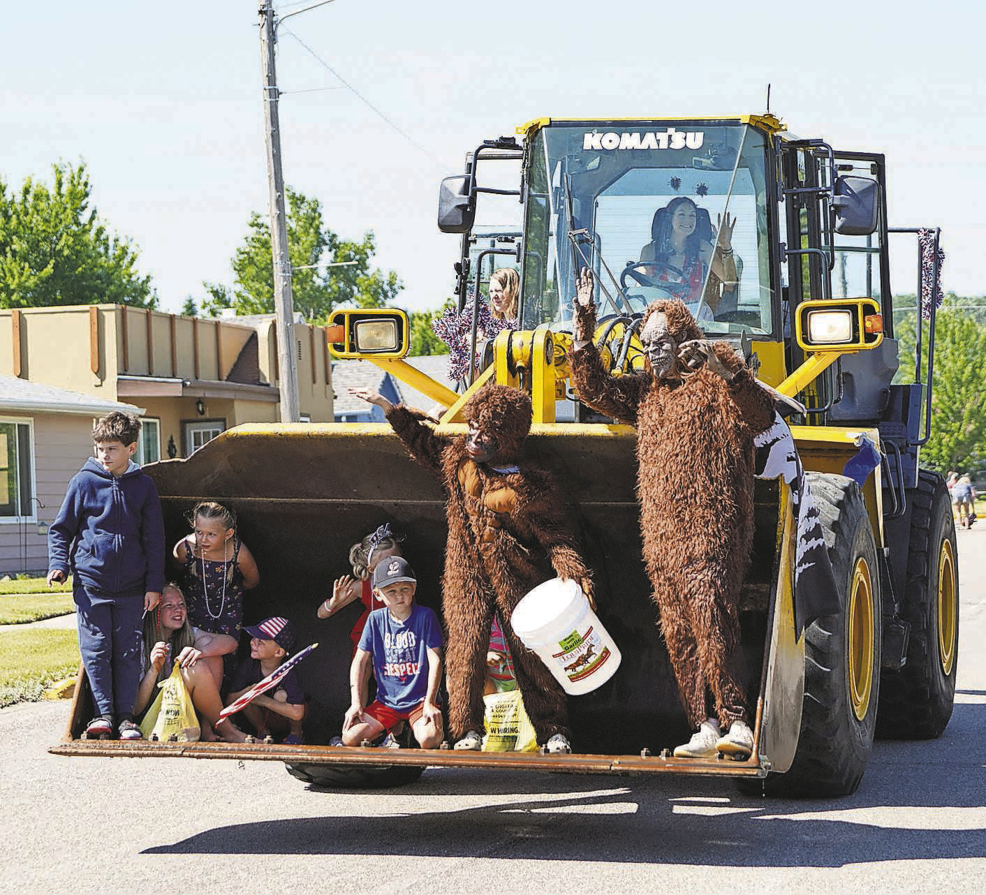 Candy throwers ride in the bucket of an excavator as part of Walhalla’s parade for the Fourth of July. PHOTO BY LARRY STOKKE