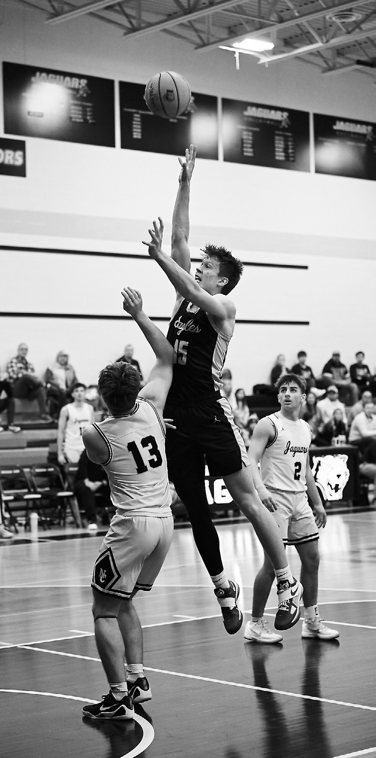 Garret Willits shoots from in front of the net. Photo by Ashley Schafer.