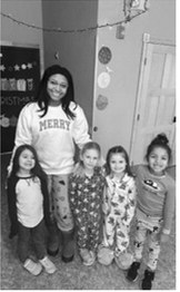 Mrs. Okwudili is pictured with students on a recent pajama day. Submitted photo