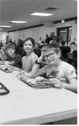 Second graders enjoy the school wide Thanksgiving meal. Submitted photo