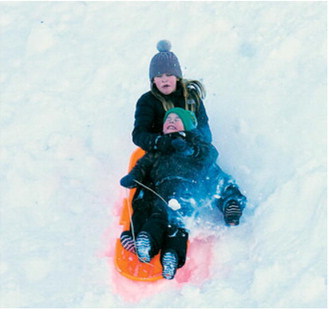 Two youngsters are captured by the camera lens sliding down a giant hill in Langdon ahead of our back-to-back blizzards last week. Larry Stokke / for the Borderland Press