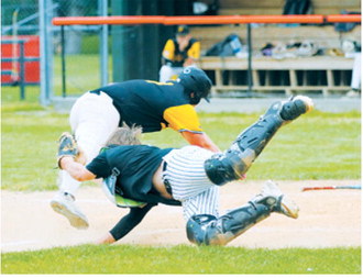 Devin Hakanson dives to apply the tag at home plate as a Park River runner attempts to score during Langdon's victory. Photo by Larry Stokke