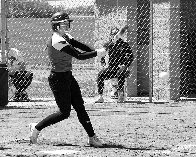 Meredith Romfo connects for a base hit against Thompson. Photo by Larry Stokke.