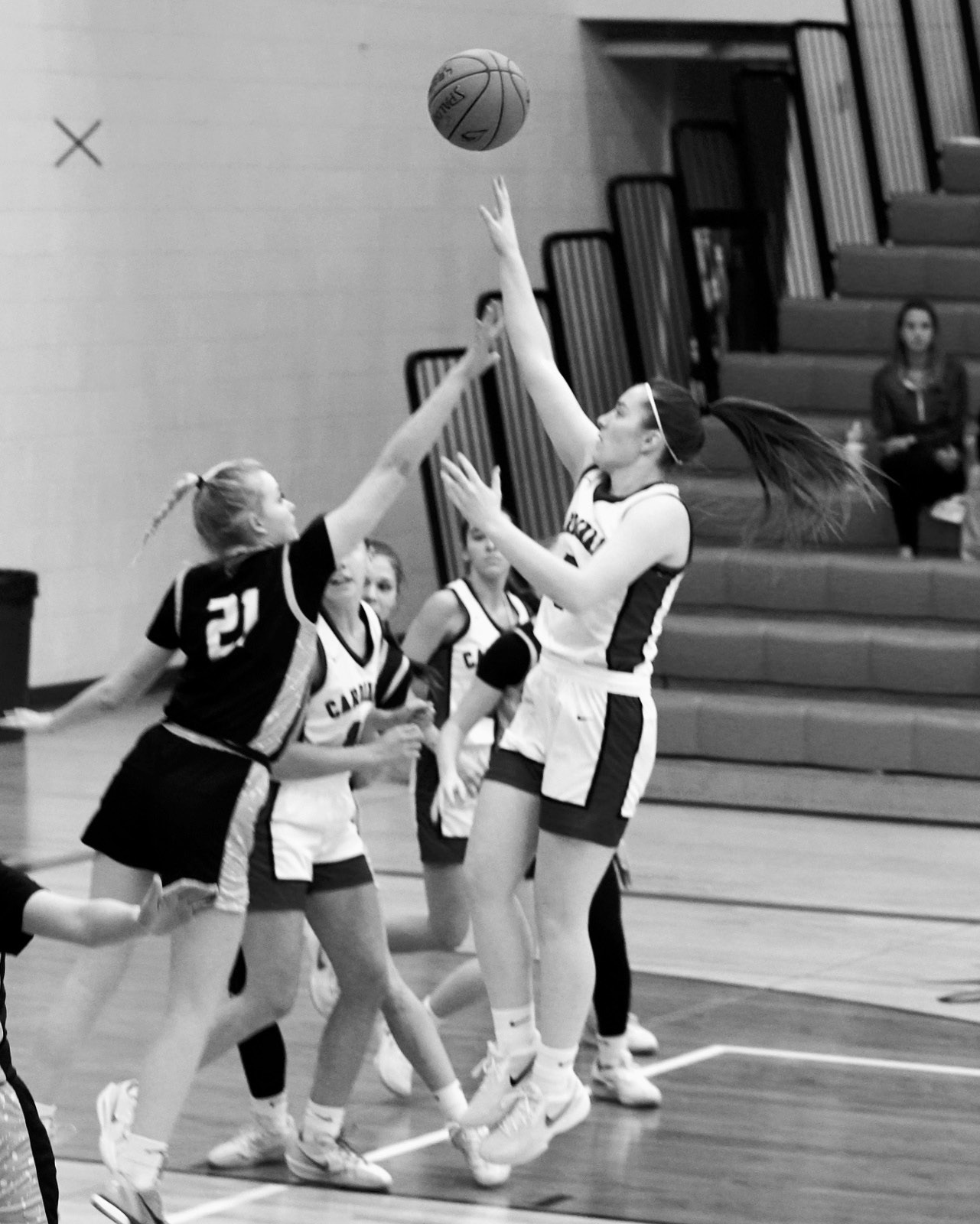 Meredith Romfo drives the lane and drops in a basket in the Cards win over Nelson County. Photo by Larry Stokke.