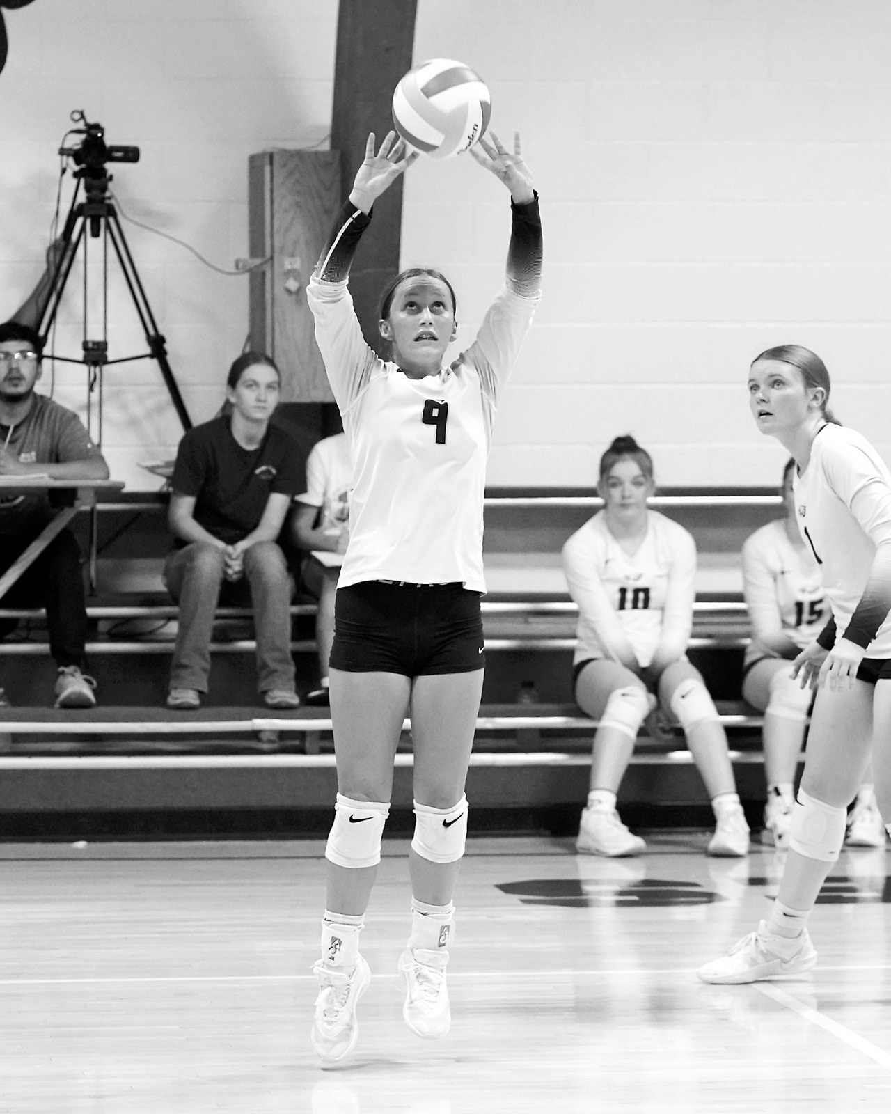 Adrienne Longtin sets the ball to a teammate in the game against the Mustangs. Photo by Larry Stokke.