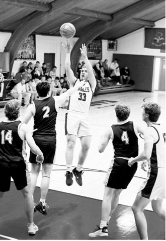 #33 Kade Schafer puts up a jumper for two of his 13 points on the night. Photo by Ashley Schafer