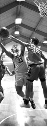#33 Kade Schafer gets in the paint for a layup in North Border’s game against North Star. Photo by Ashley Schafer