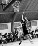 #21 Brody Berg drives in for a basket. Photo by Ashley Schafer