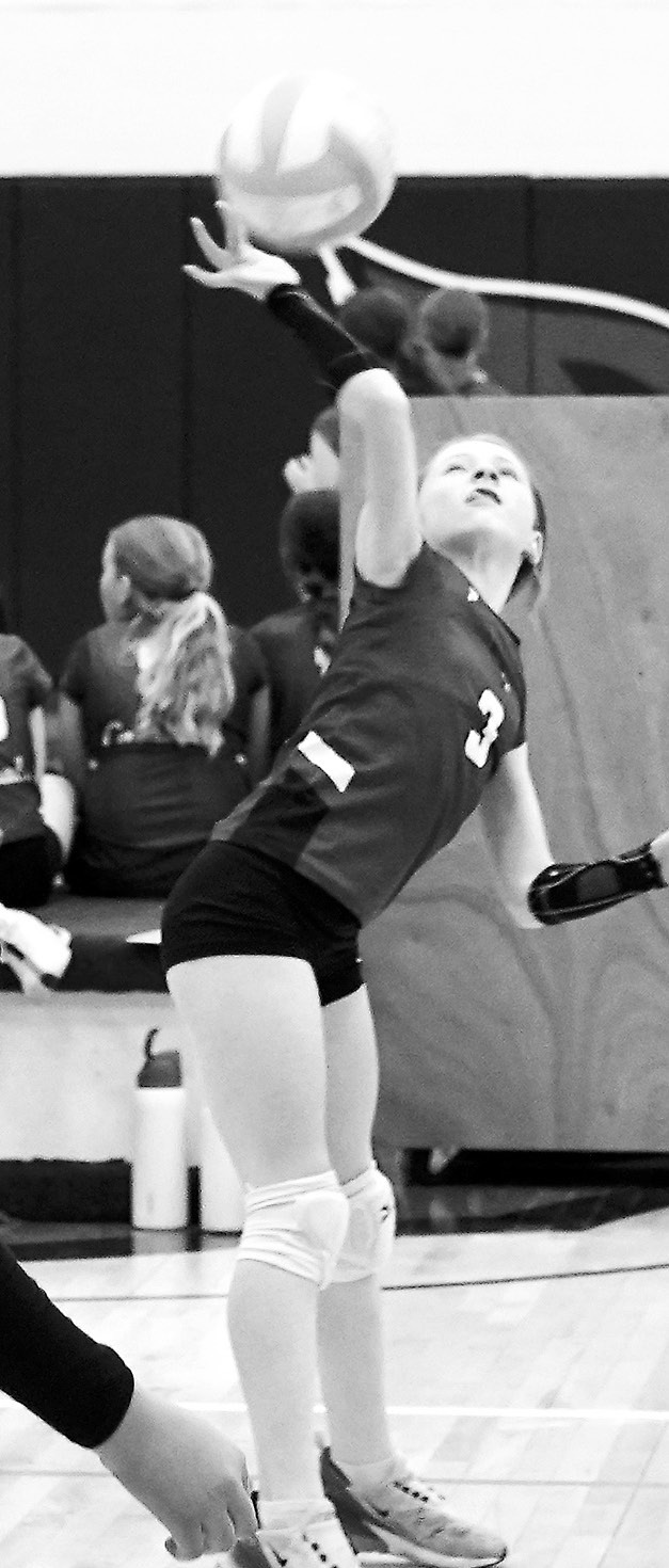 Tori Olson sends the ball over the net for a point in the win over the Lakota Raiders. Photo by Larry Stokke.