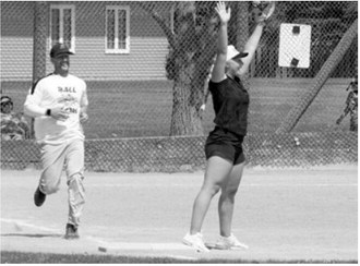 McKenna Schneider makes the catch at first base to record an out against Zack Schaefer during the co-ed softball tournament. Photo by Larry Stokke
