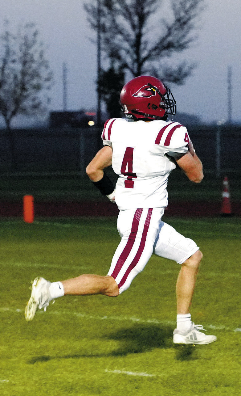 Sam Davis scores on a 63-yard run then kicks for an extra point in the win over the Grafton Spoilers. Photo by Larry Stokke.