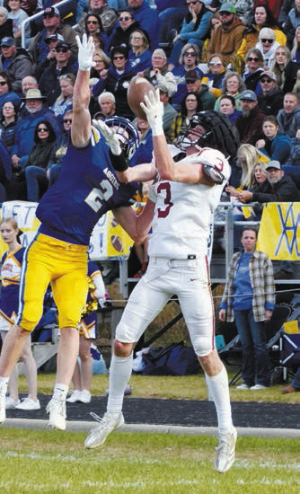 Cody Amble, who has been named Region 2A Senior Athlete of the Year, leaps up for a catch in the game against the Aggies on Nov. 9. Photo by Larry Stokke.