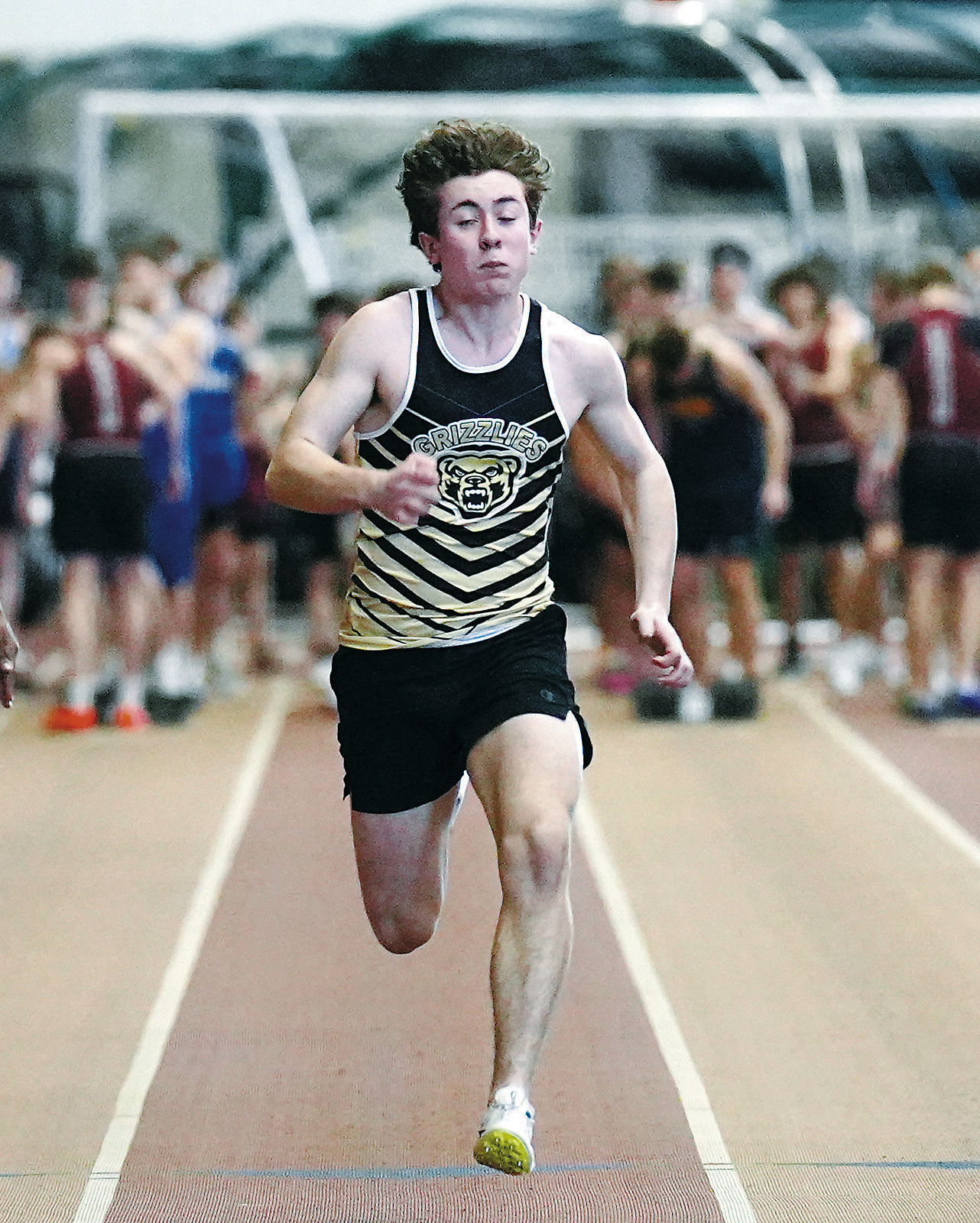 Logan Heuchert ran the 200 meter race. Photo by Larry Stokke