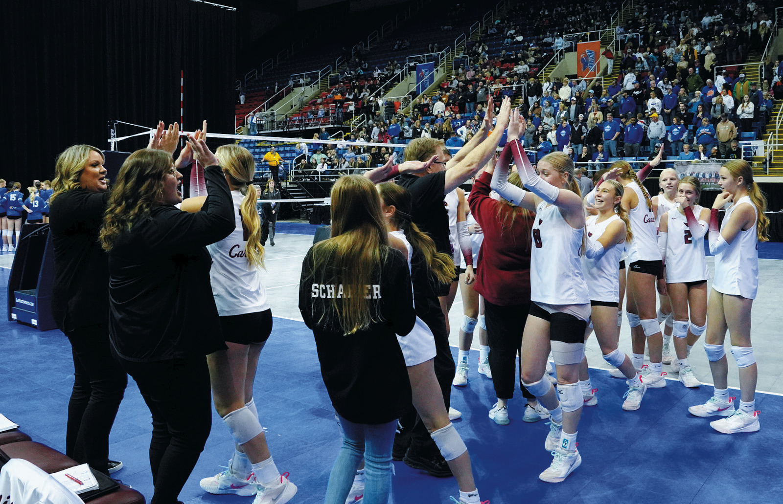 The Langdon Area-Munich girls volleyball team getting pumped up during the Class B State Tournament. Photo by Larry Stokke.