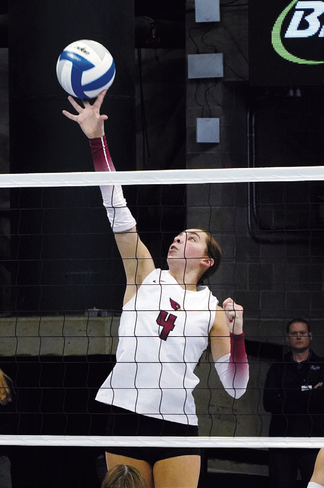 Avery Lorenz sends the ball over the net. Photo by Larry Stokke.