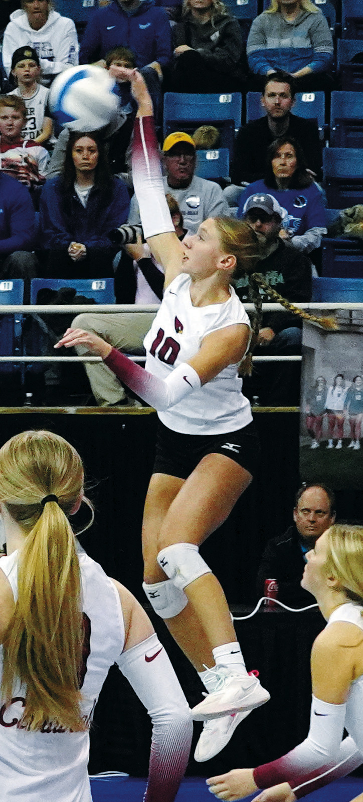 Aubrey Badding leaps into the air to spike the ball over the net against Thompson in the state championship game. Photo by Larry Stokke.