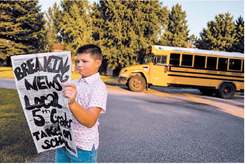 Sean Gonzalez, a fifth-grader at Langdon Area Elementary School, shares some “breaking news” as he prepares to head back to school. Photo courtesy of Celica Gonzalez
