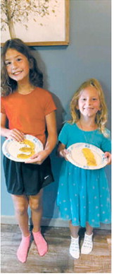 Amelia, a third-grader left, and Aubrey, a first-grader, show off their pancake “grades” before heading to the first day of school. The family started the tradition three years ago. Photo courtesy of Kristi Hennager