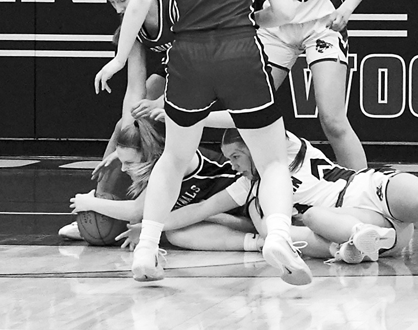 Mikaela Olson fights for a loose ball in St. John on Jan. 9. Photo by Larry Stokke.