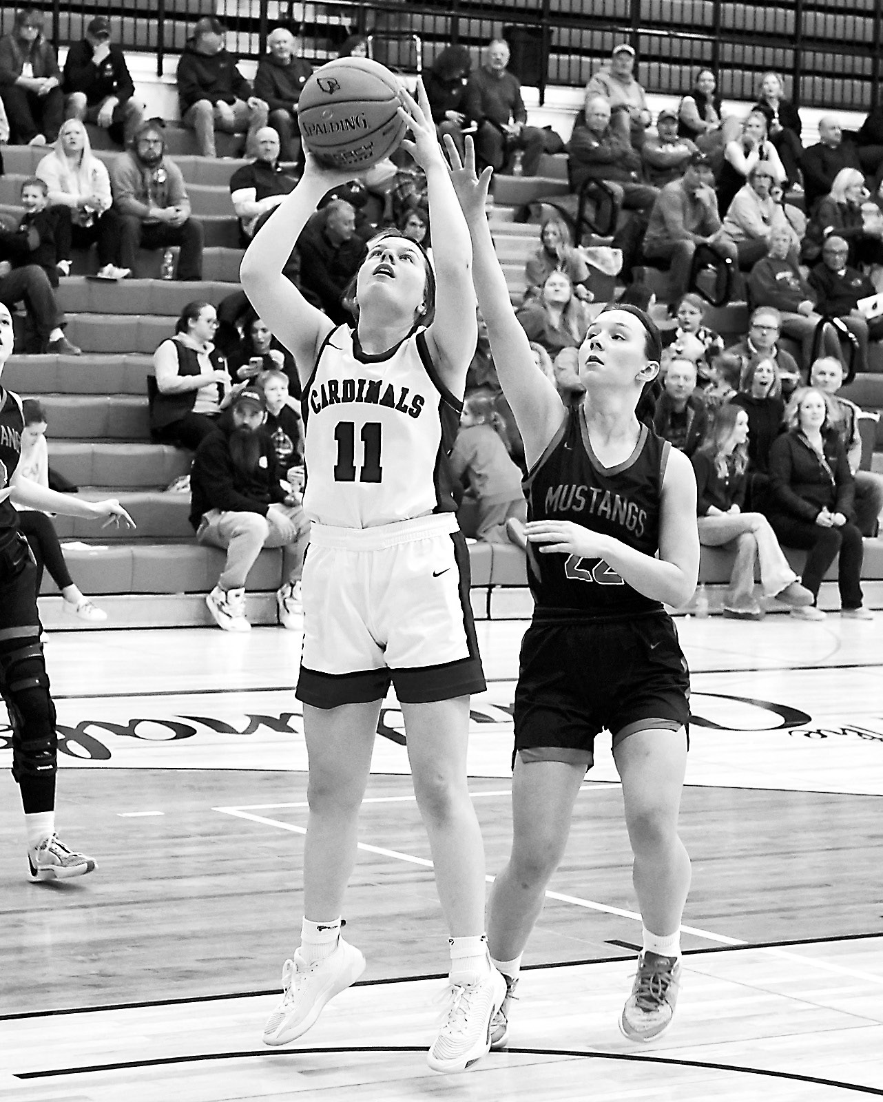 Erika Bakke drops in a basket in the Lady Cards' win over Midway-Minto. Photo by Larry Stokke.