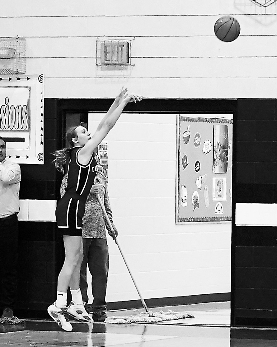 Kemi Morstad fires off a 3-point shot in the Cards' win in St. John. Photo by Larry Stokke.