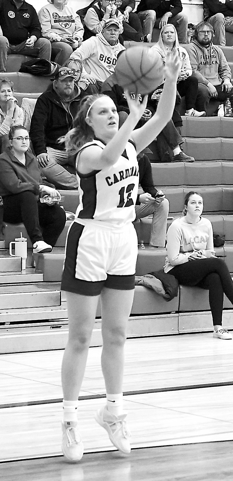 Mikaela Olson sinks a bucket against Midway-Minto. Photo by Larry Stokke.
