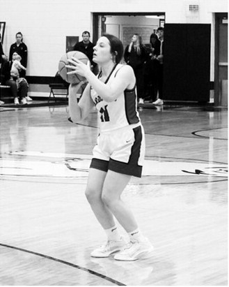 Erika Bakke eyes the basket and drains a three-point shot in the win over the Aggies. Photo by Larry Stokke