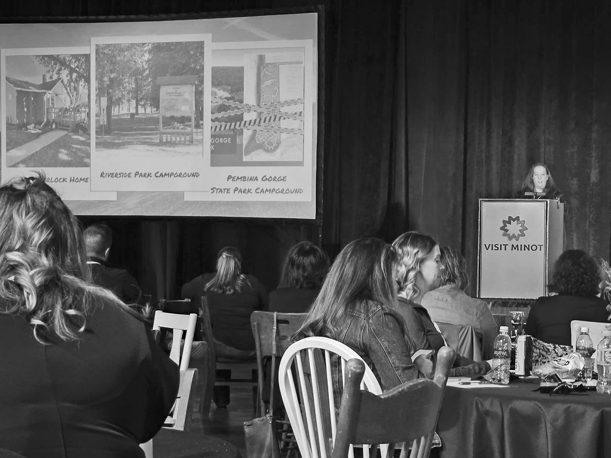 Presenting on Walhalla in front of the crowd at the tourism conference.