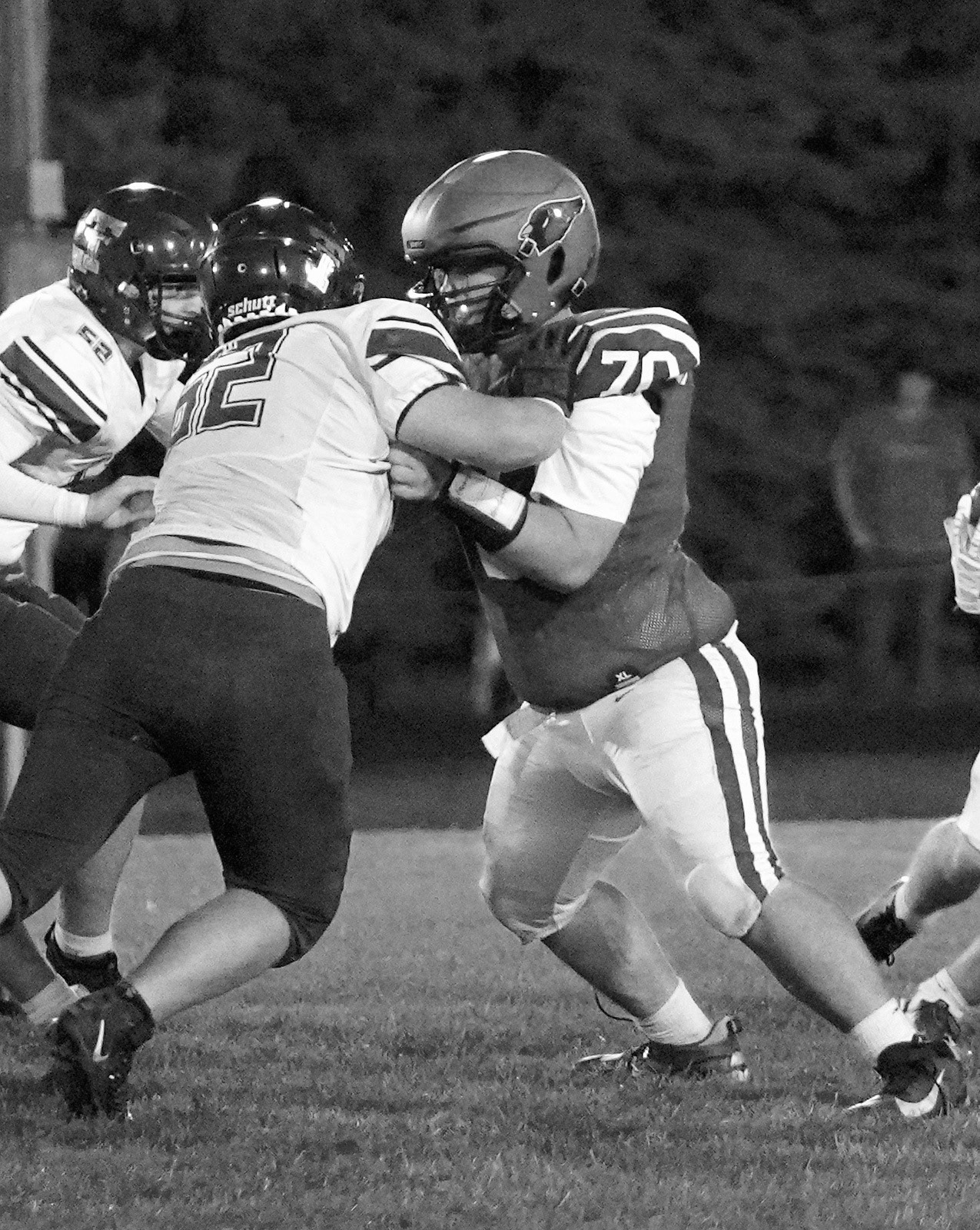 Jonathan Christie takes on two Tommies, protecting the Cardinal's quarterback, Jax Johnson. Photo by Larry Stokke.