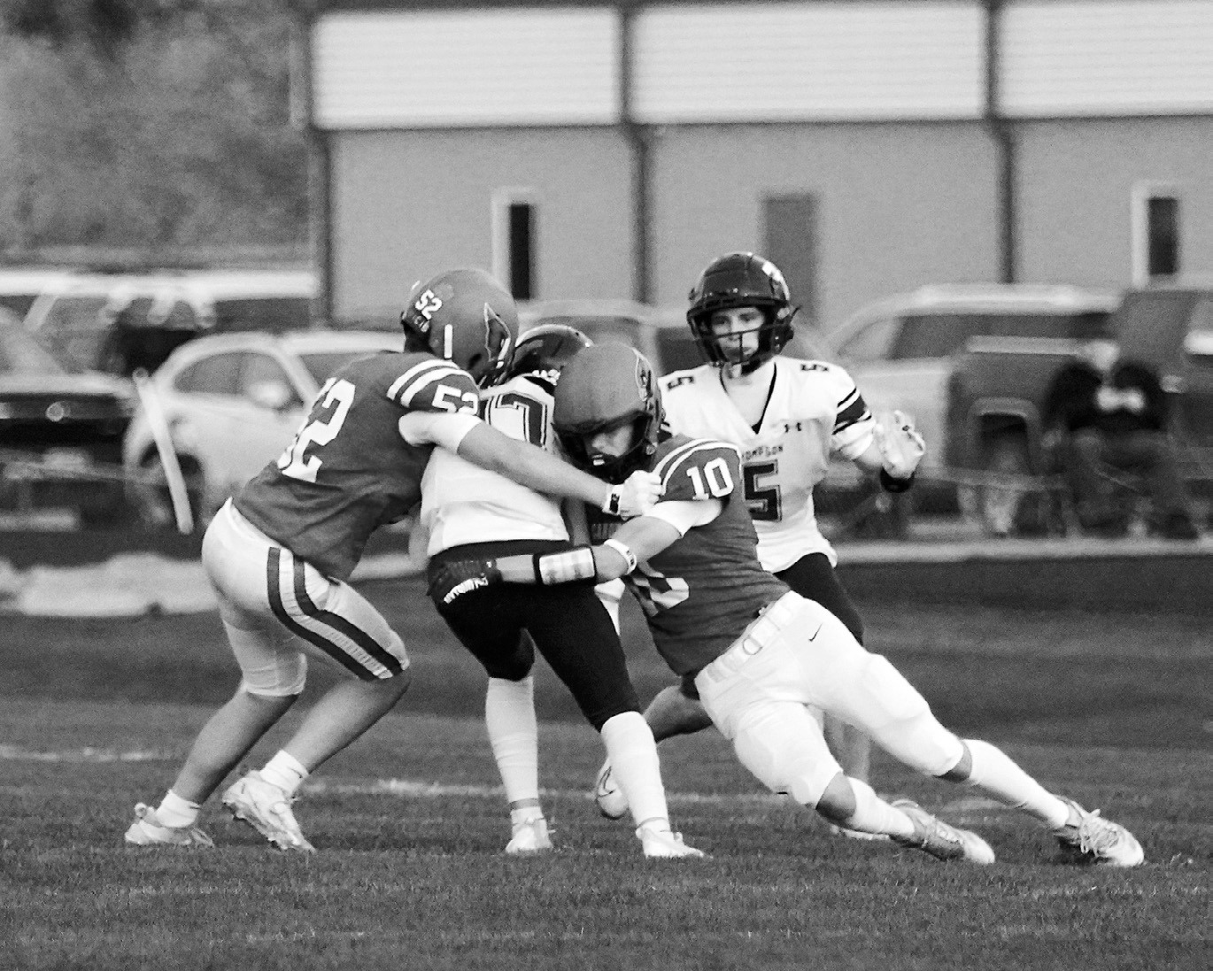 Maddux Stremick and Dawson Downs stop a Tommy from gaining any forward yardage. Photo by Larry Stokke.