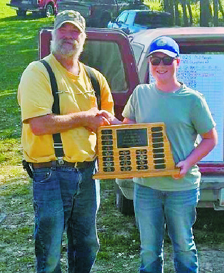 Range officer Coby Dalgliesh (left) with Wesley Meidinger (right) hold the championship plaque at the North Dakota State F-Class Mid-Range Shooting Competition. Wesley is the youngest in the state to hold the first place title.