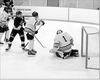 Keaton Ullyott, with the assist from Max Henderson, sends the puck into the net scoring a goal for the Blades. Photo by Larry Stokke