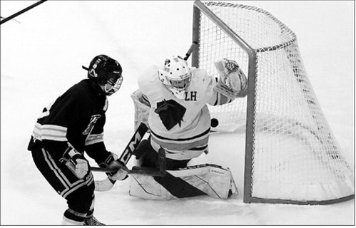 Max Henderson fires the puck past the Stallions goalie in Langdon Jan. 17. Photo by Larry Stokke