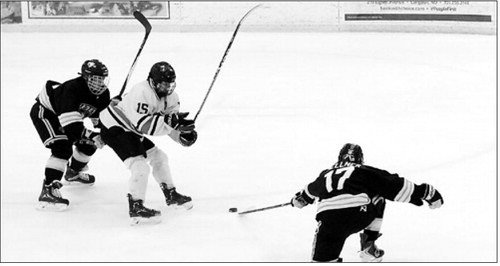 Tucker Gellner gets his stick on the puck knocking it away from the Stallion offense player. Photo by Larry Stokke