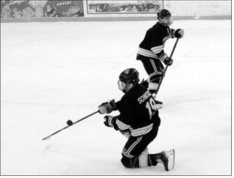 Landon Schneider bats the puck away from the Blades net Jan. 17 at the Dakota Spirit Arena. Photo by Larry Stokke