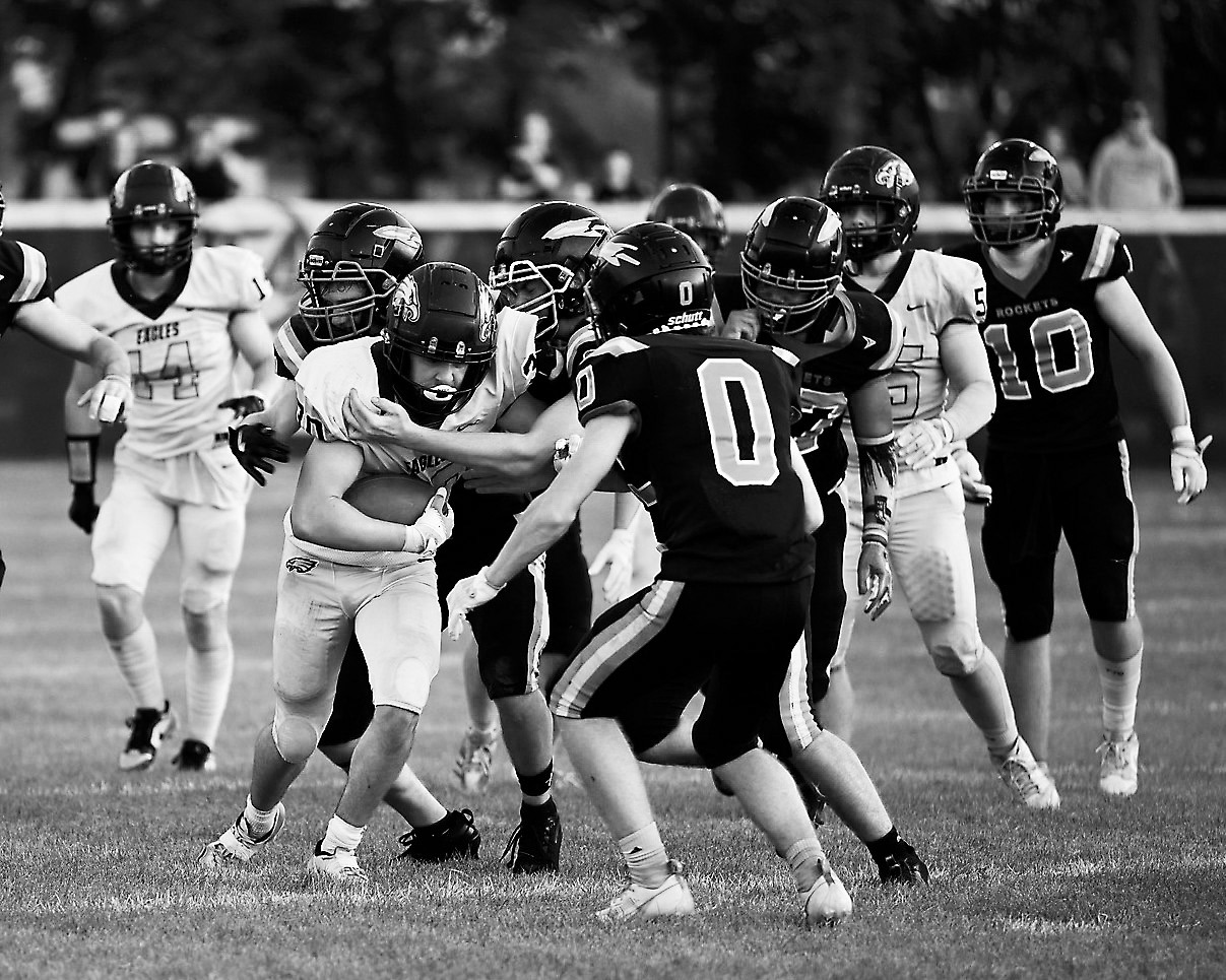 Brody Berg fights for extra yardage as multiple defenders converge to bring him down. Photo by Ashley Schafer.