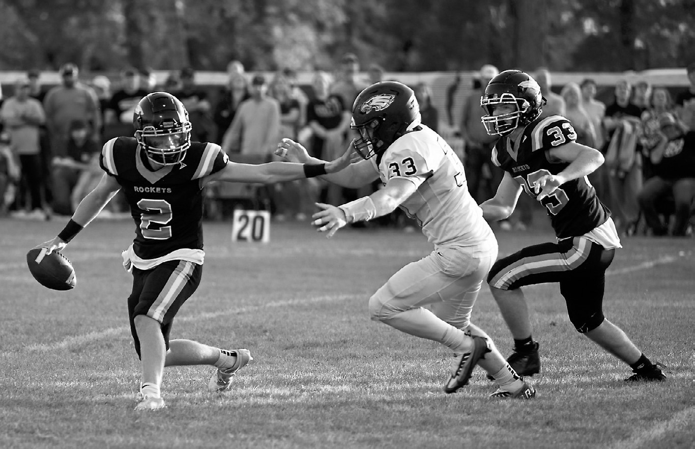 Kade Schafer putting the pressure on the Rockets QB. Photo by Ashley Schafer.