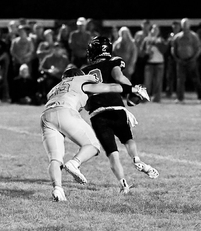 Gavin Symington breaks through the line to sack the quarterback. Photo by Ashley Schafer.