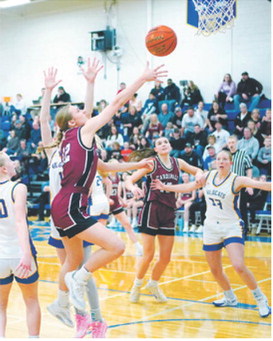 Kemi Morstad drives into the lane and puts up a shot. Photo by Larry Stokke