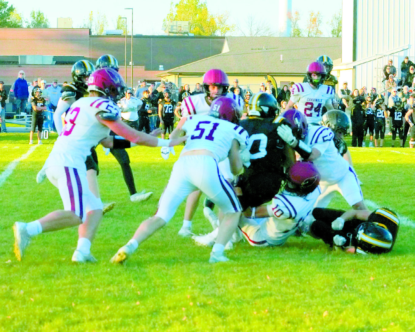 An Aggie ball carrier is stopped from making a first down by a flock of Cardinals in Park River. Photo by Larry Stokke.