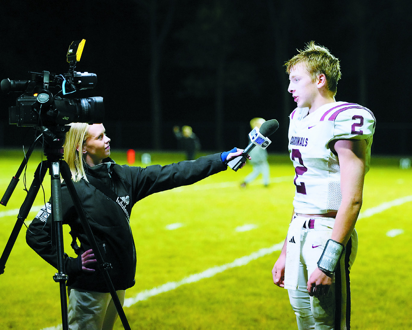 Kenzie Iserman with WDAY out of Fargo interviews Jax Johnson after the Cards' win over the Park River Aggies on Oct. 10. Photo by Larry Stokke.
