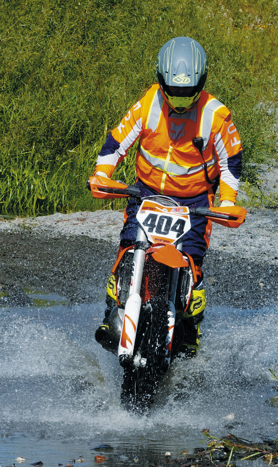 Ben Girodat runs through the water crossing at the Peterson Hare Scramble Sept. 8. Photo by Larry Stokke.
