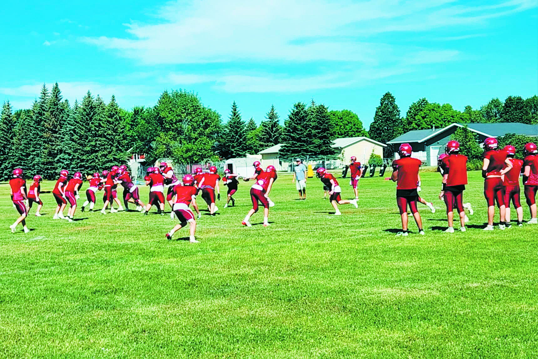 The Cardinals highschool football team practicing on the field on Monday