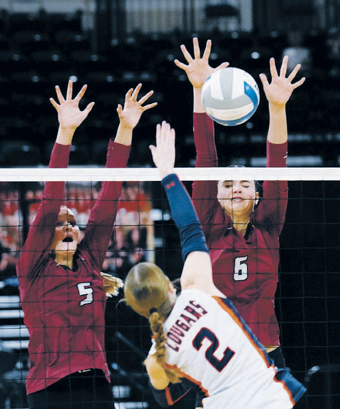 Hallie Overby and Taya Feist team-up to stuff block a Cougar player. Photo by Larry Stokke