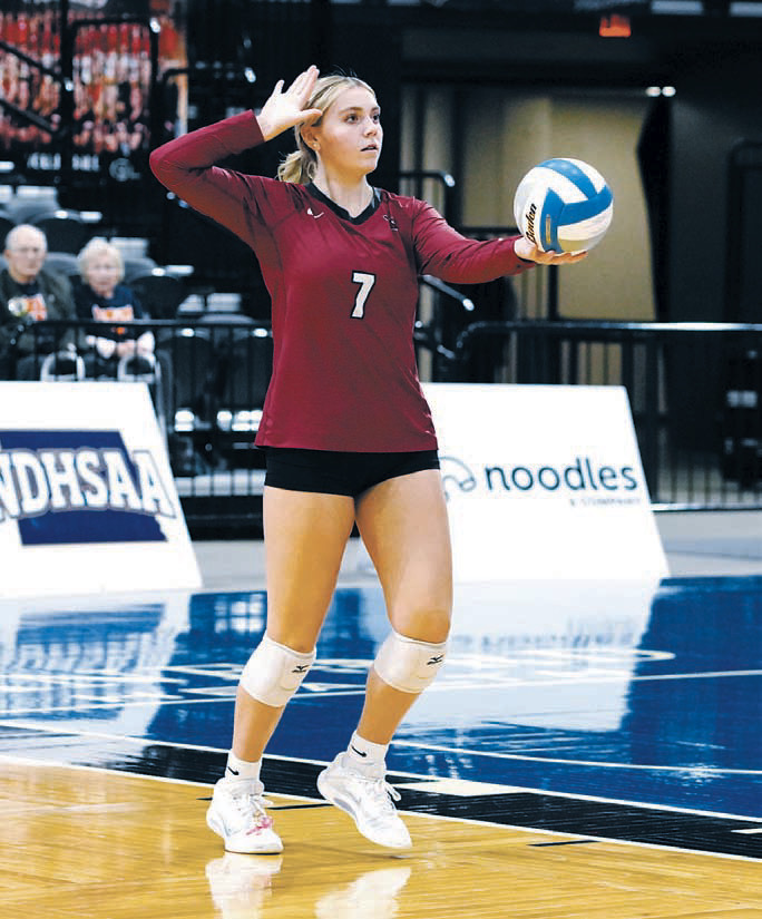 Liv Prouty sends an ace over the net in the first game of the State Tournament. Photo by Larry Stokke.